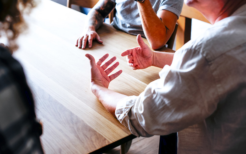 People Discussing At Table