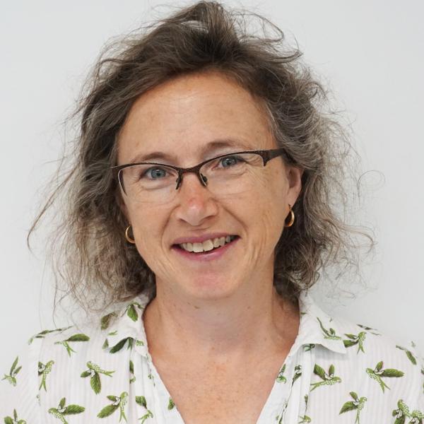 Dr Emma Gordon pictured. White woman with glasses, shoulder length hair, and white shirt.